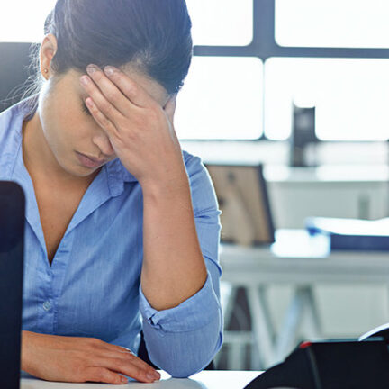 Shot of a businesswoman experiencing stress at work